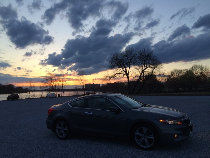 Gray Honda Accord in front of sunset sky.