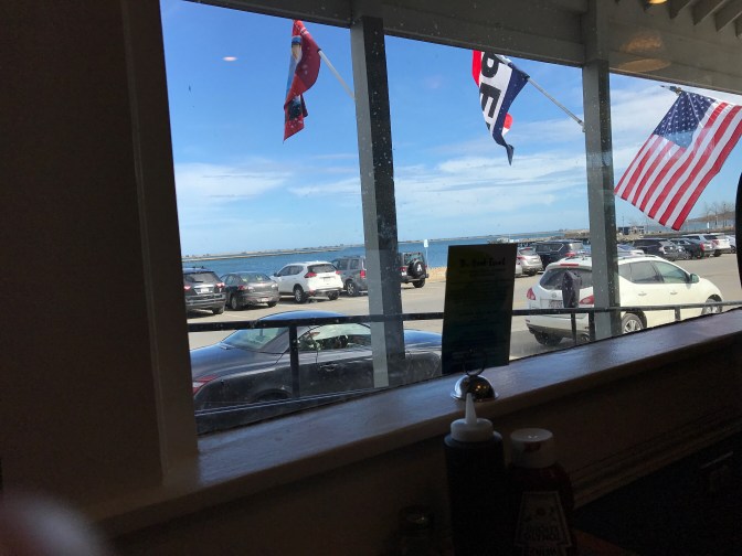 View of the Plymouth shoreline through a restaurant window.