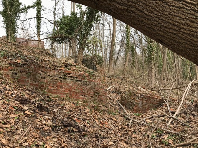 Brick wall along river bank.