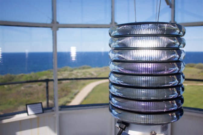The lighthouse light inside of the lantern room.
