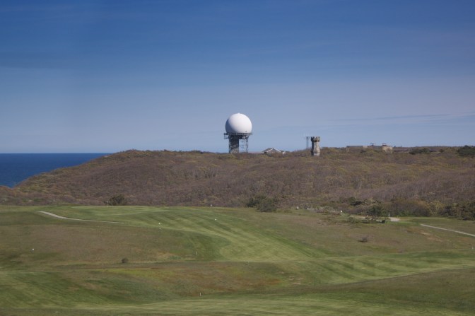 From top of lighthouse, view of radar dome and stone tower from nearby air force base.