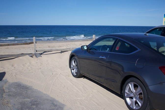 Honda Accord in foreground, beach and ocean in background.