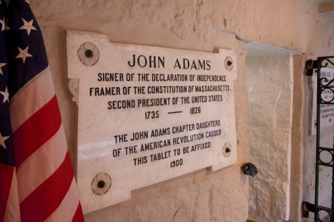 Sign indicating the burial place of John Adams in the crypt beneath the church.