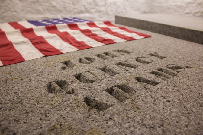 Tomb of John Quincy Adams, with a flag at the head of the tomb.