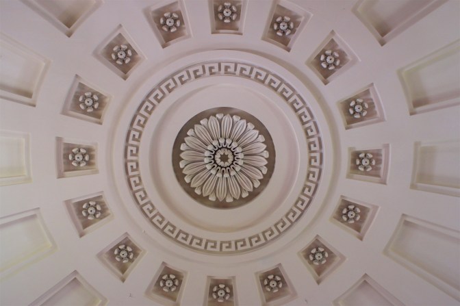 Looking upward at ornate church ceiling.