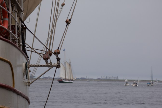 Rigging of Europa, with a sailing vessel in the background.