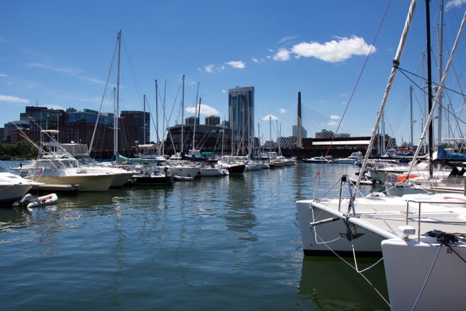 Boston Harbor, filled with pleasure crafts, while the skyline is in the background.