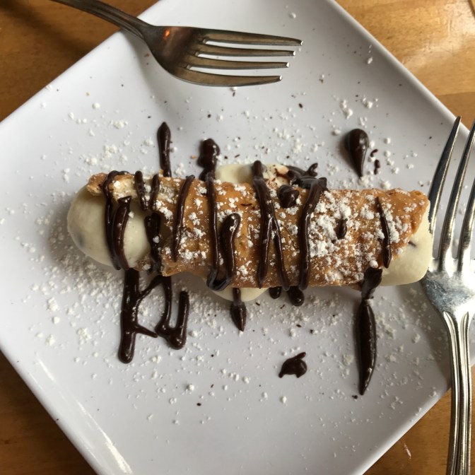 Cannoli on a plate, with two forks.