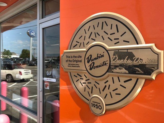 Sign outside of Dunkin Donuts commemorating it as the location of the original Dunkin Donuts store.