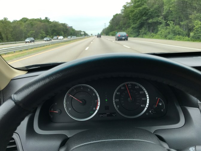 View of Route 24 in Massachusetts, with vehicle dashboard in foreground.