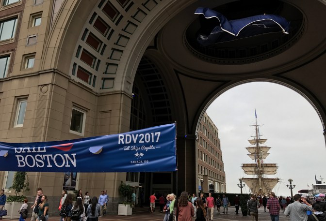 Entrance to Sail Boston, with a tall ship in the background.