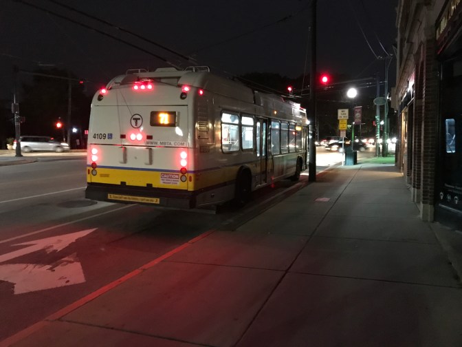 MBTA Bus parked beside road.