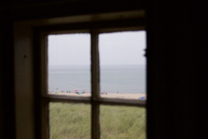 View of beachgoers through one of the station windows.