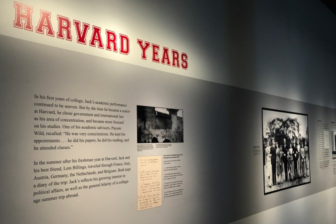 Wall display of John's college years at Harvard.