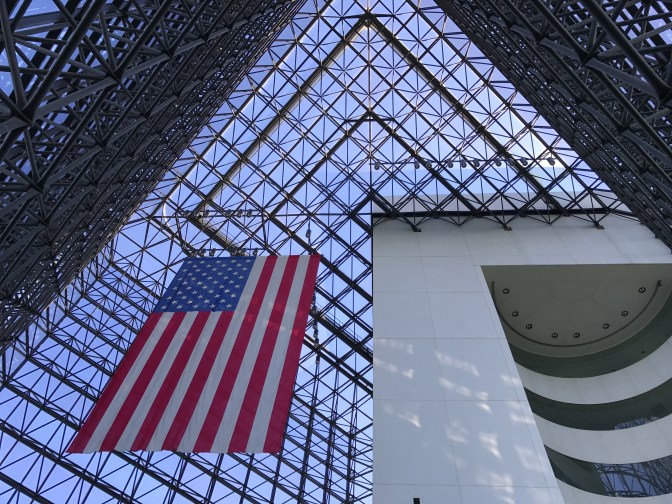 Atrium of Kennedy Library, looking upward toward large American flag.