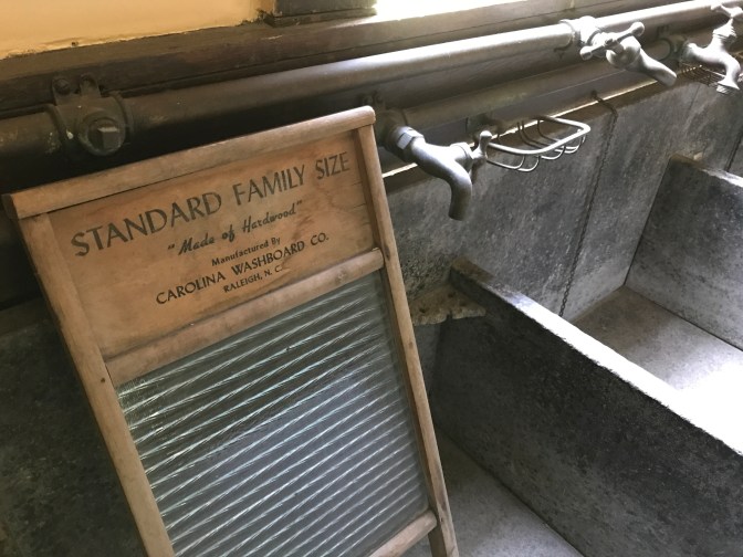 Sink in laundry room with wash board in sink.