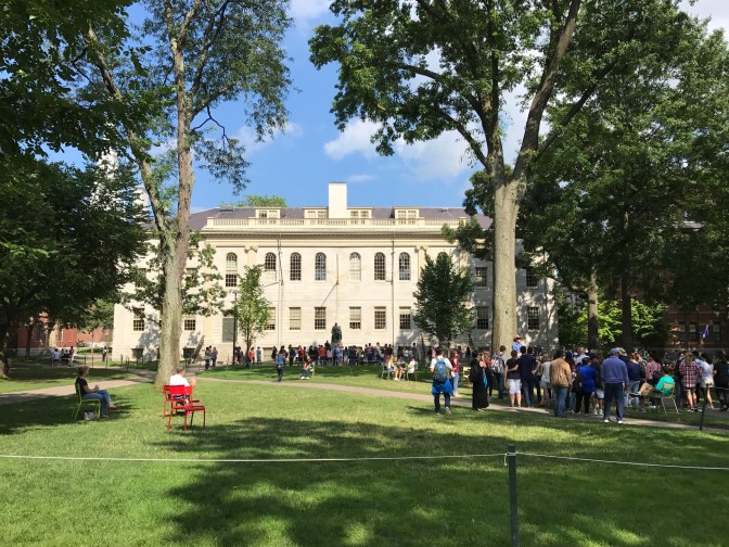 Harvard Yard, looking toward University Hall. Crowds of tourist fill the lawn in front of the building.