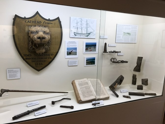 Display on the sinking of the HMS Somerset. It includes pieces of the ship, a book, and several informational panels.