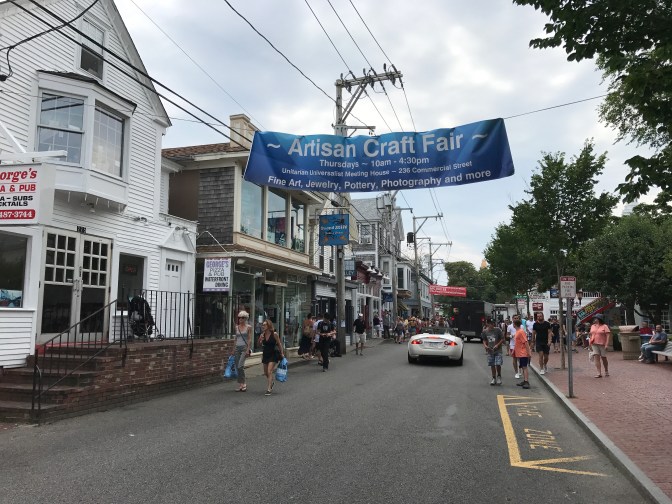 Commercial Street in Provincetown, with pedestrians walking along the street.