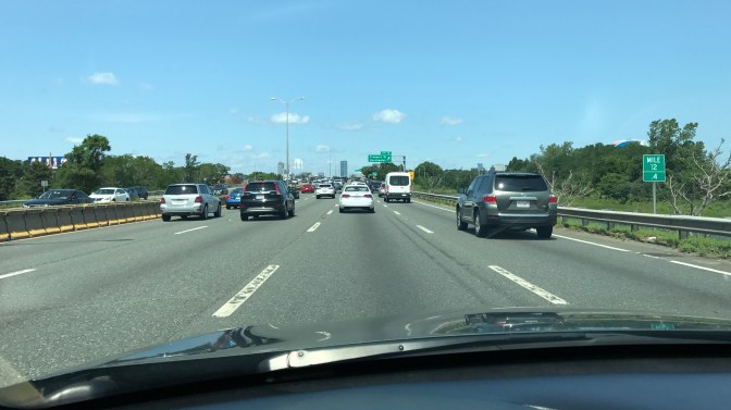View of traffic on I-93 Northbound. The Boston skyline is in the distance.