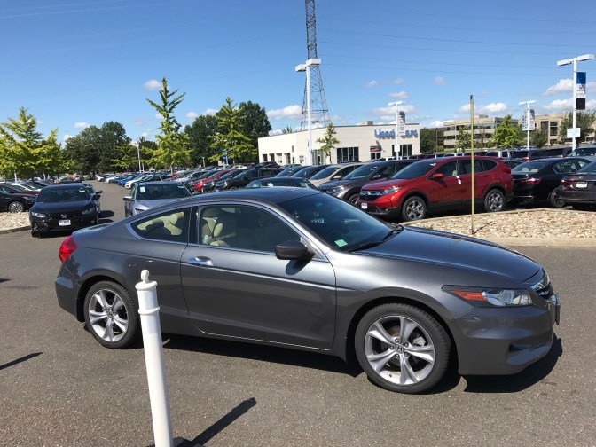 2012 Honda Accord coupe in the Honda dealership parking lot.