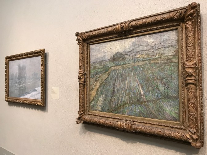 Two paintings by Van Gogh hanging on the wall.