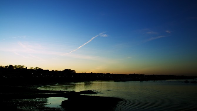 Plymouth Harbor, with the sun almost set in the background.