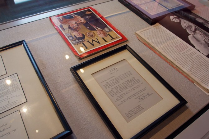 Glass case of magazine articles regarding the Kennedys, as well as their correspondence.