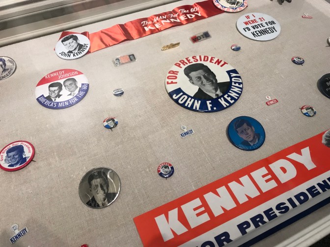 Pins, buttons, and bumper stickers supporting President Kennedy's election.