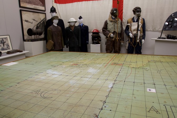 Air map table and mannequins of pilots in uniform.