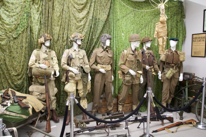 Allied soldiers uniforms, displayed on mannequins.