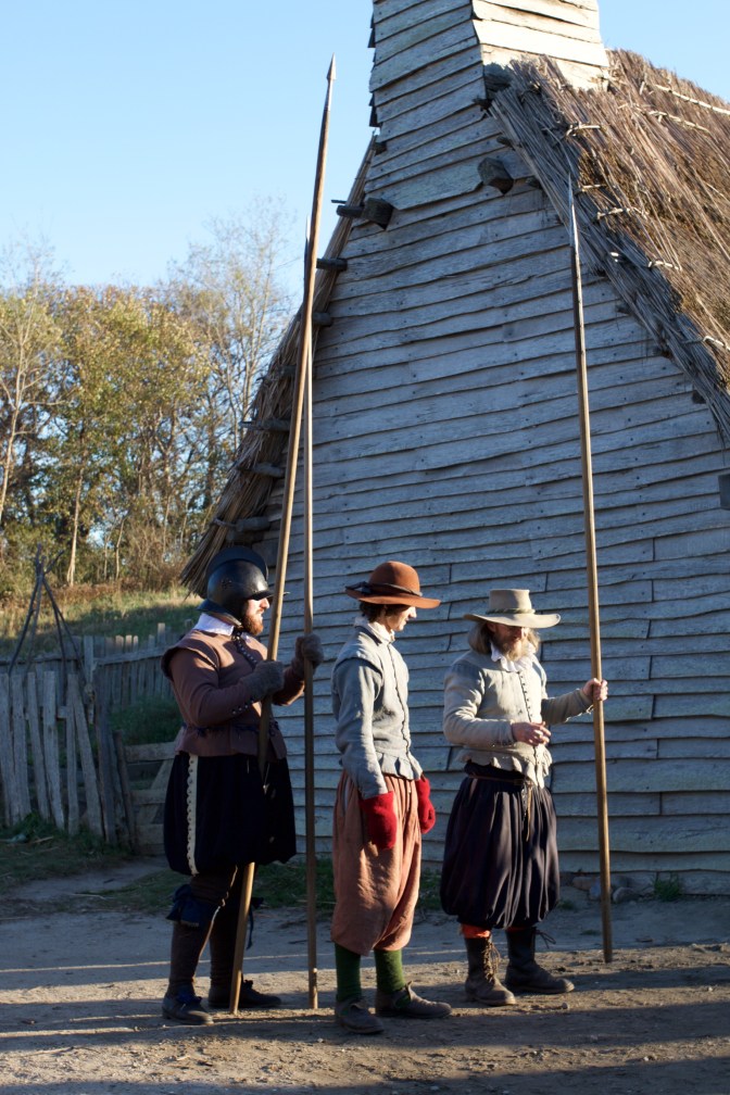 Three actors portraying guardsmen of the Village. They all hold pikes.