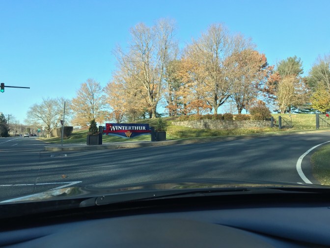 View of the entrance to the museum, with the Winterthur sign by the driveway.