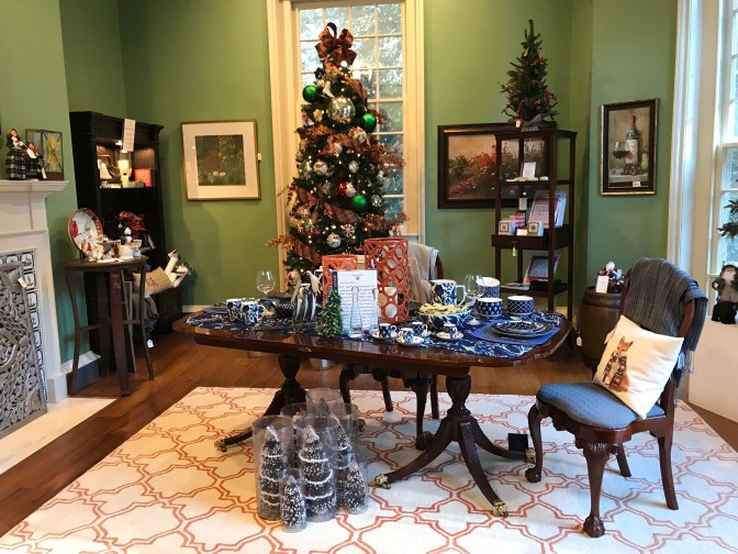 Interior of the gift shop. A table in the foreground has items for sale. A Christmas tree is in the background.
