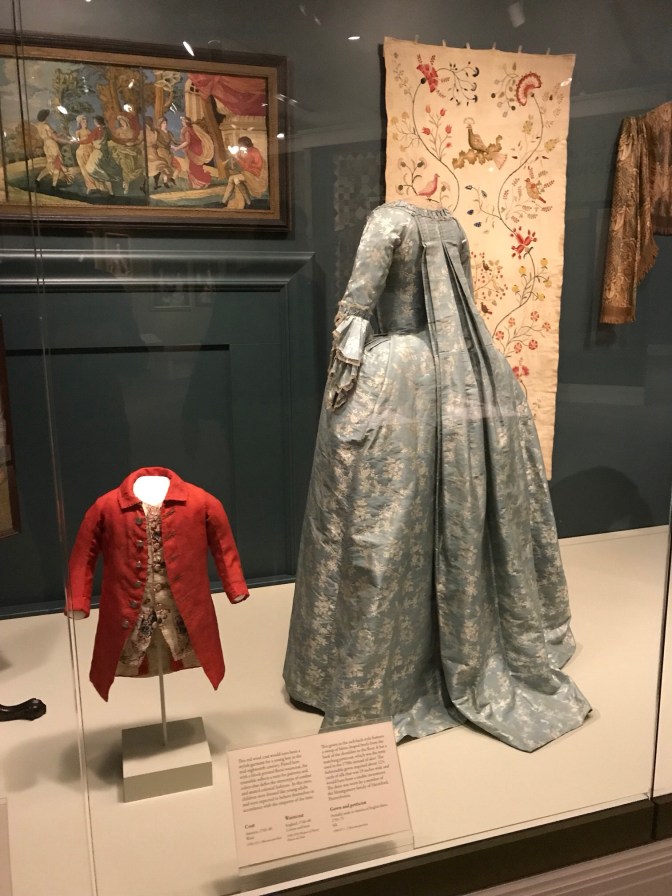 A boy's coat and a woman's gown and petticoat, both from the 18th century.