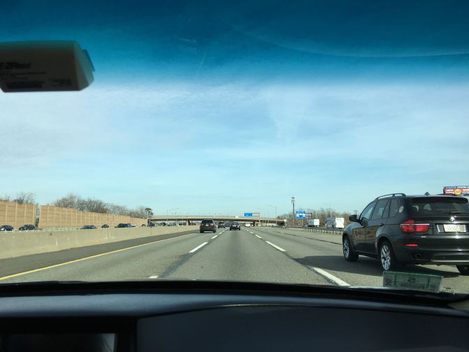 View of the NJ Turnpike through the windshield.