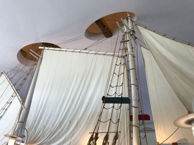 Masts extending through holes in the ceiling.