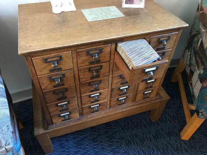 Card catalog with open drawer.