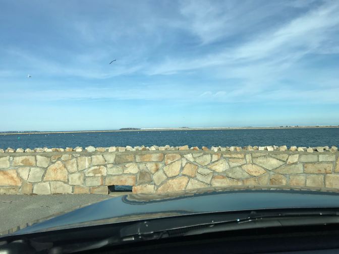 View of Plymouth Harbor from behind wheel of car.