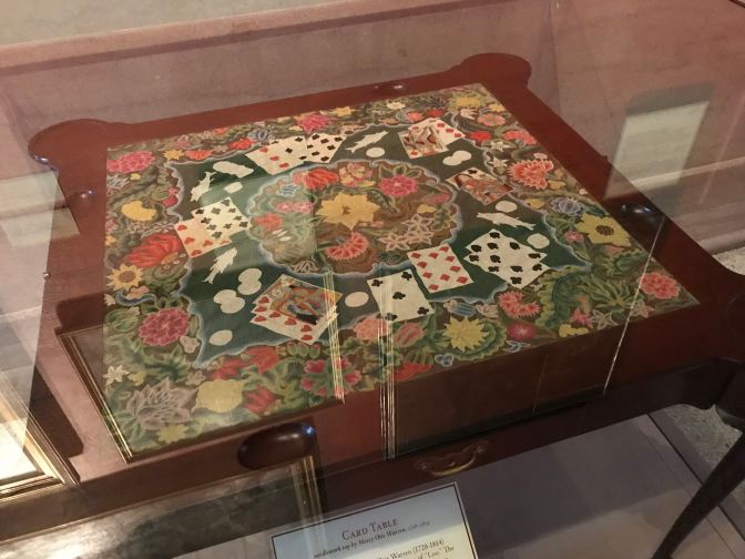 Card table with embroidered top.