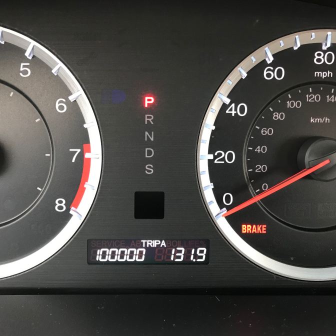 View of car odometer reading 100000 miles.