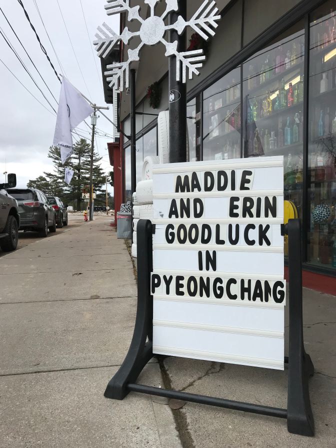Sign outside of hardware store that says "Maddie and Erin Goodluck in Pyeongchang."