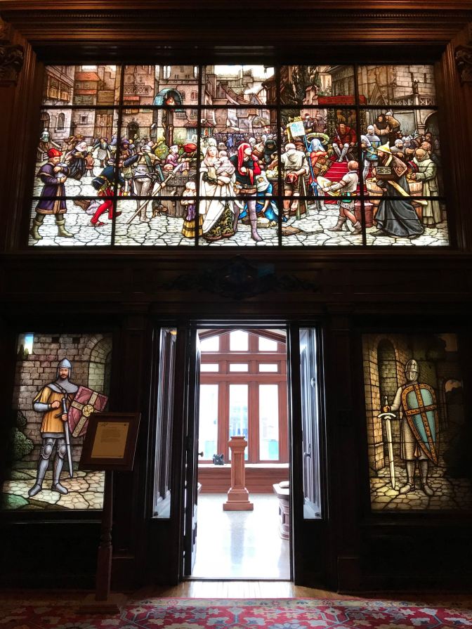 Stained glass windows above and beside entrance door to Solarium.