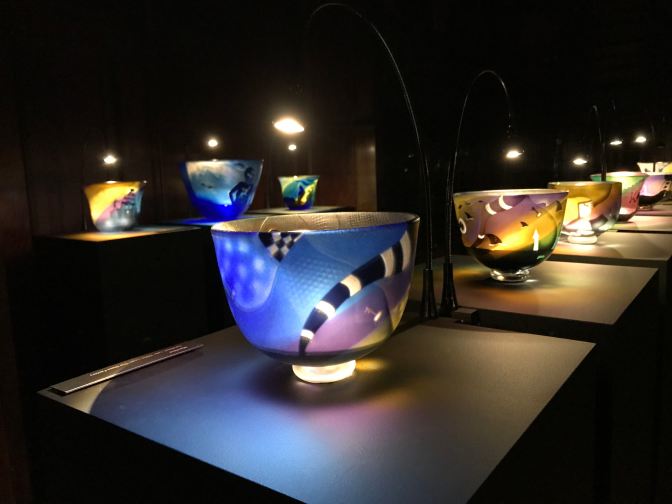 Glass bowls on display in art installation.
