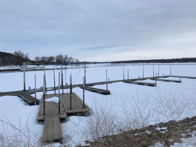Frozen St. Croix River, with docks in the foreground.