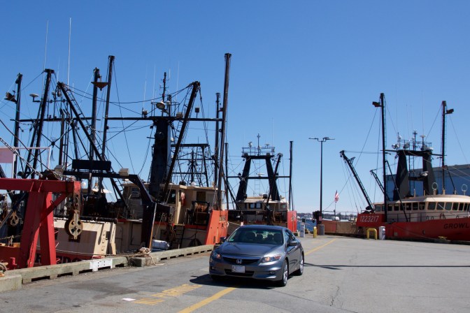 2012 Honda Accord parked beside fishing vessels.