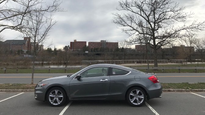 2012 Honda Accord, in front of a river and buildings.