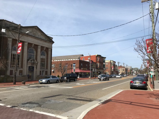 Broadway Road in Salem, Massachusetts. Cars are parked on either side of the road.