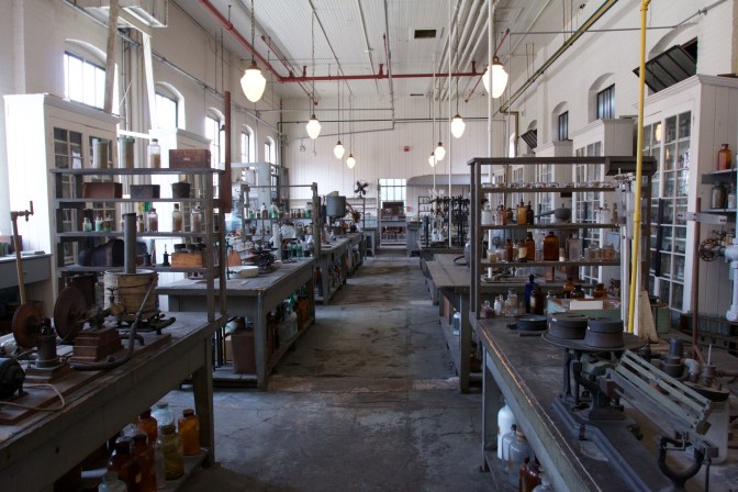 Interior of the Chemistry Lab. Machines and bottles fill the tables in the lab.