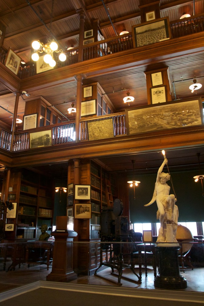 Edison Laboratory library, with a large statue on the ground floor of a three-level room.